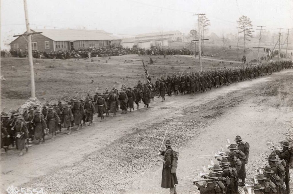 The 115th Infantry Regiment passes the review stand at Camp McClellan, Anniston, Alabama, during a divisional review for the 29th Division, 18 February 1918. The 115th was later consolidated with the 175th Infantry. (National Archives)